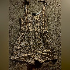 This is a cheetah print romper that has never been worn. It is a size Small!
